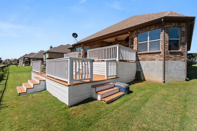 a view of backyard with deck and seating area