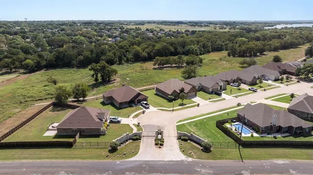 an aerial view of houses with yard