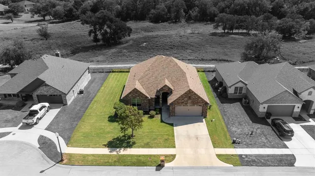 an aerial view of a house with a yard