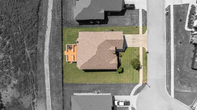 an aerial view of a house with outdoor space