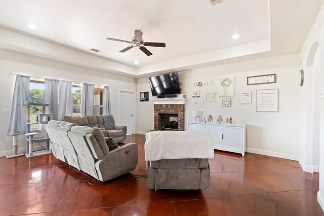 a living room with fireplace furniture and a wooden floor