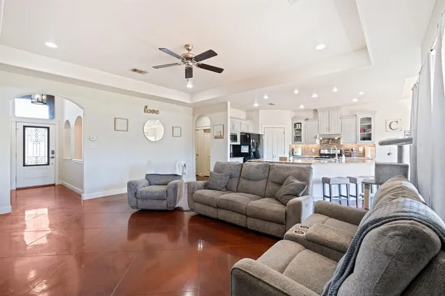 a living room with furniture and kitchen view