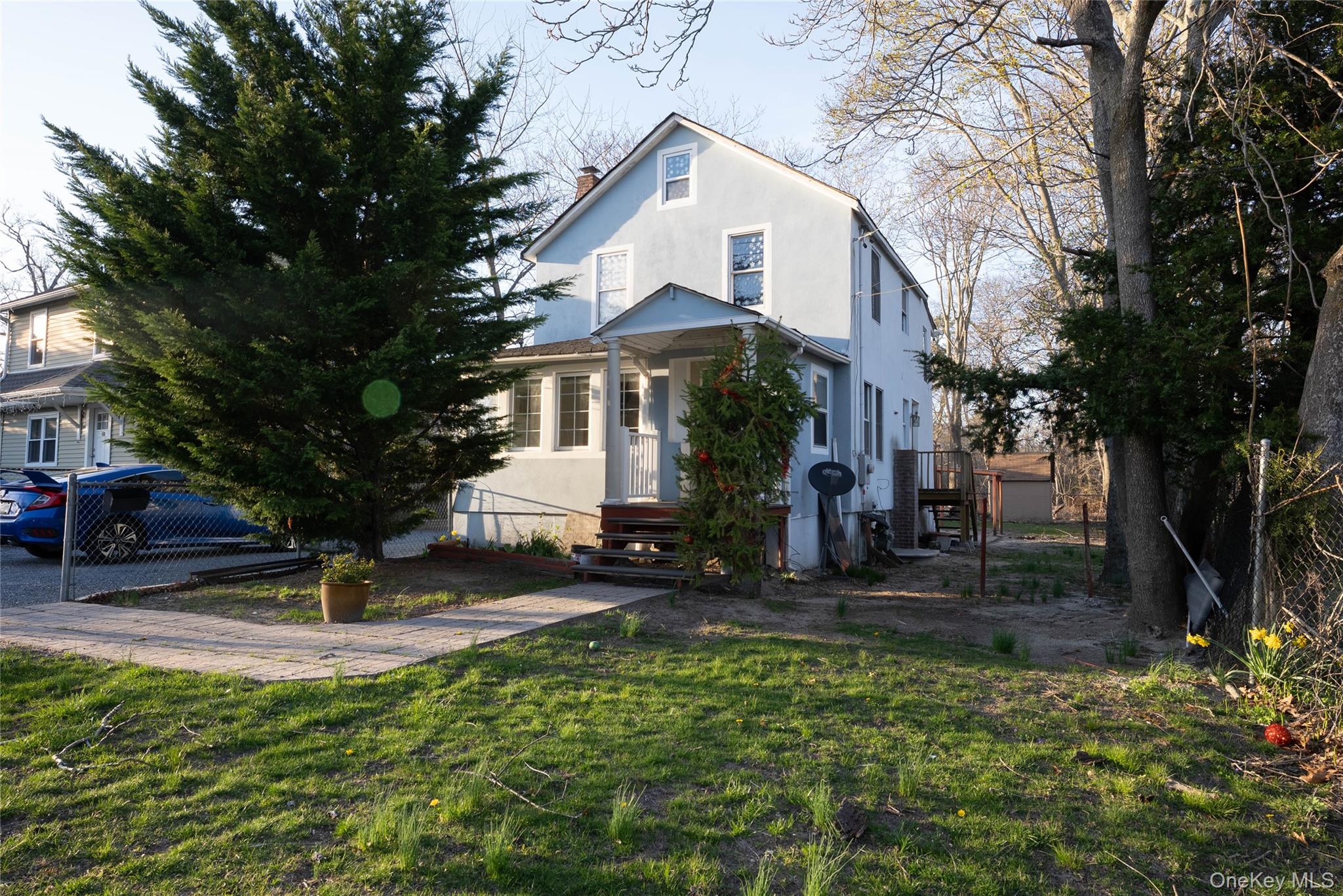 420 Flanders Road Flanders, NY 11901 - Photo 1 of 1 Traditional home featuring a chimney, a front yard, and stucco siding