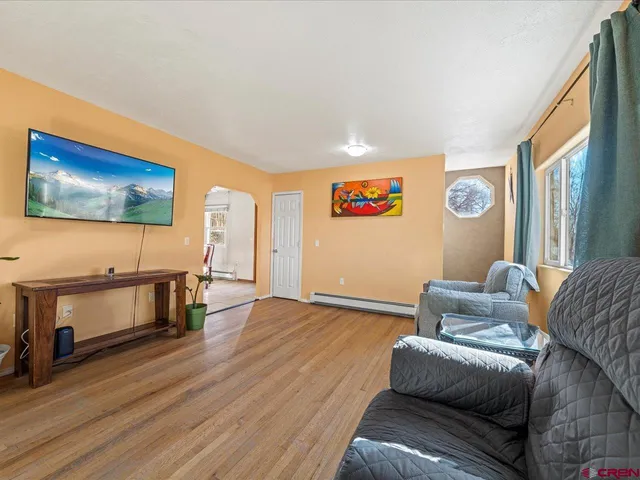 a living room with furniture and a flat screen tv