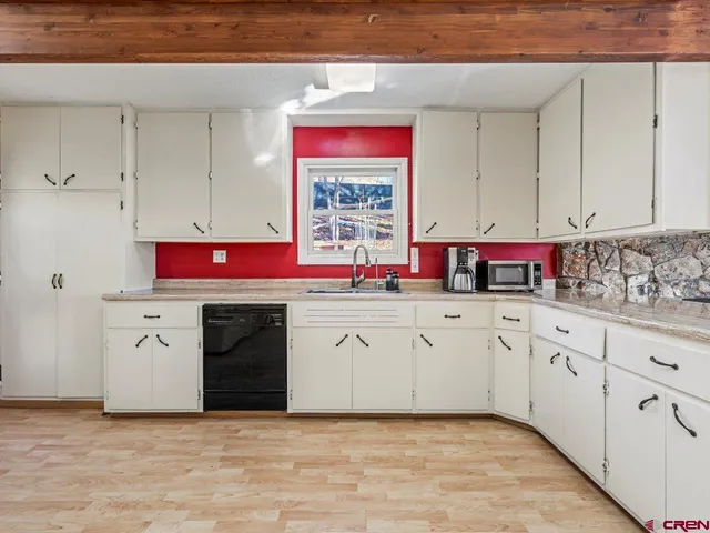 a kitchen with stainless steel appliances granite countertop a stove sink and cabinets