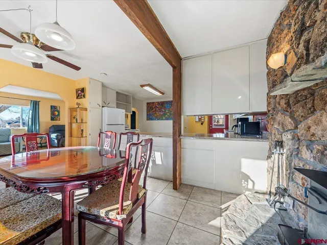 a dining room with furniture and wooden floor