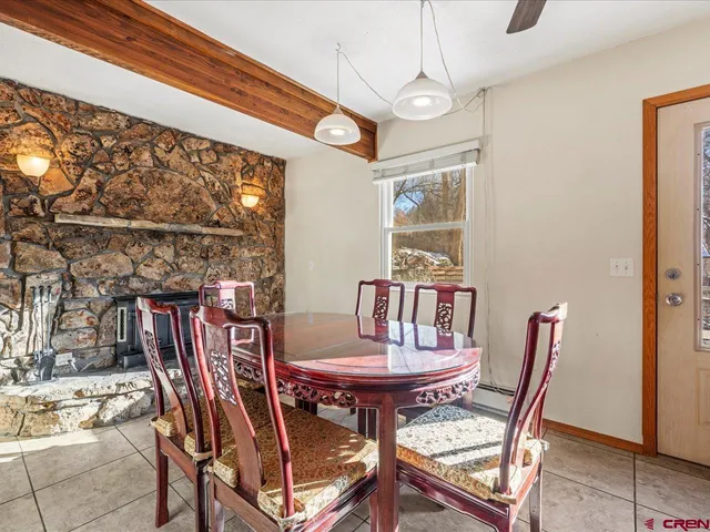 a view of a dining room with furniture and a window