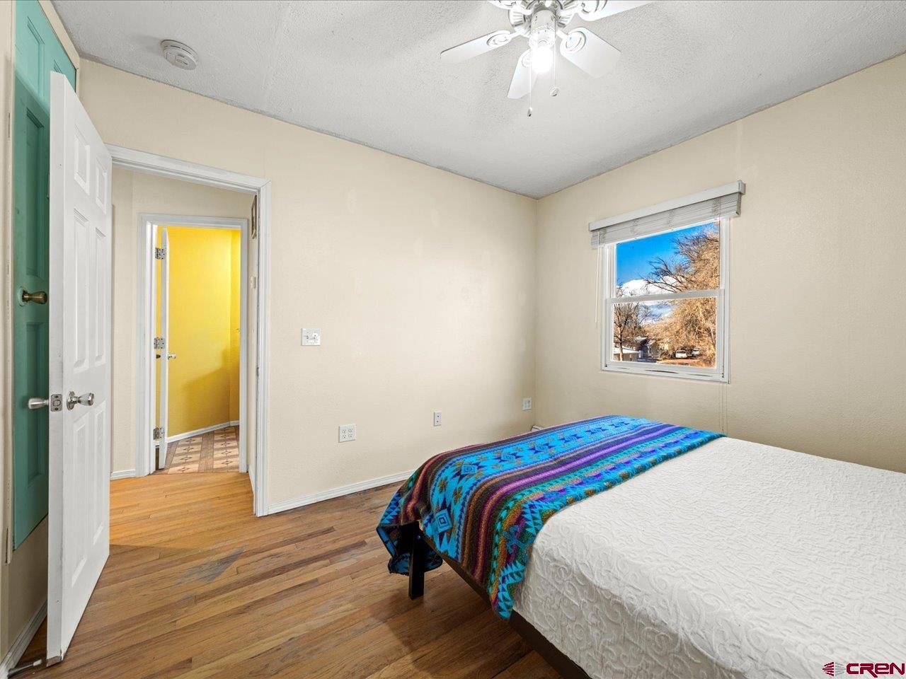 608 Bluff Street Delta, CO 81416 - Photo 2 of 45 a bedroom with a bed and a chandelier