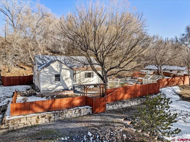a view of a yard with large trees