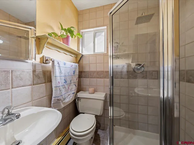 a white toilet sitting next to a bathroom sink