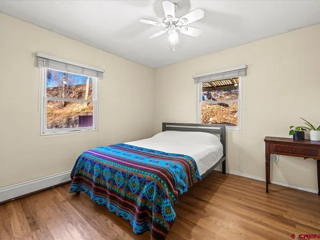 a bedroom with a bed and a painting on the wall