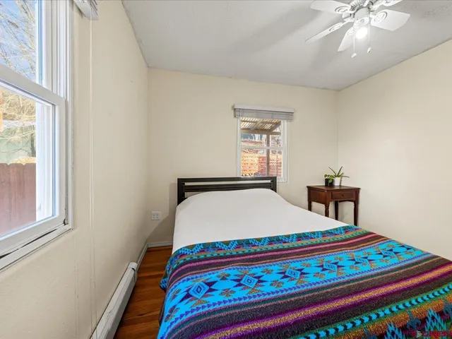 a bed sitting in a bedroom next to a window