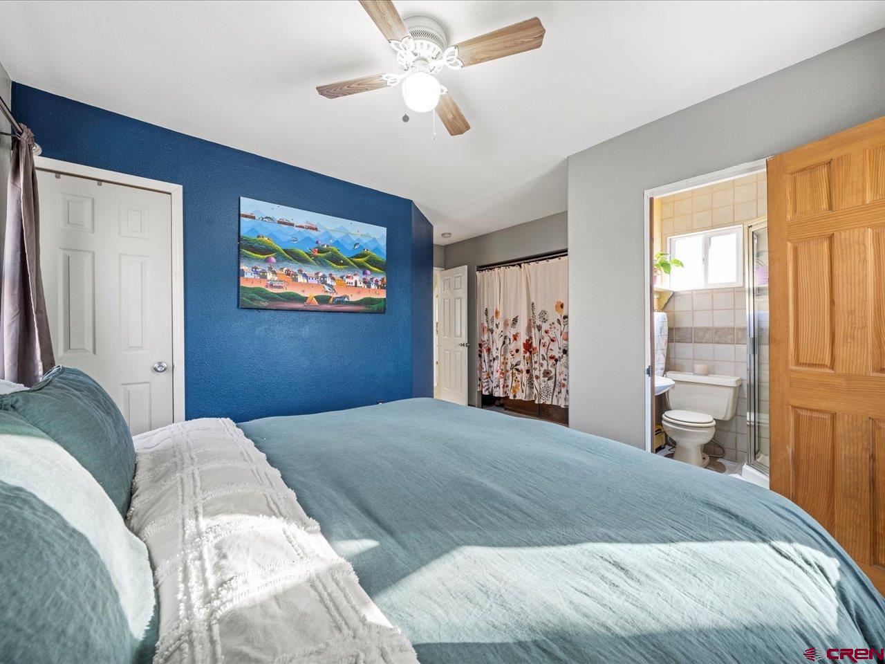 608 Bluff Street Delta, CO 81416 - Photo 34 of 45 a bedroom with a large bed and a window