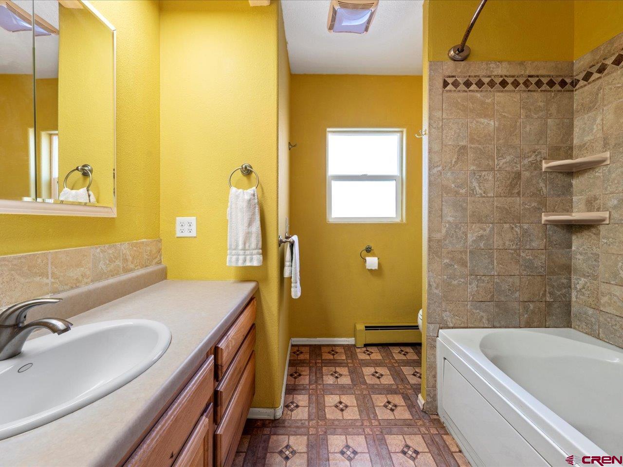 608 Bluff Street Delta, CO 81416 - Photo 38 of 45 a bathroom with a tub sink and mirror