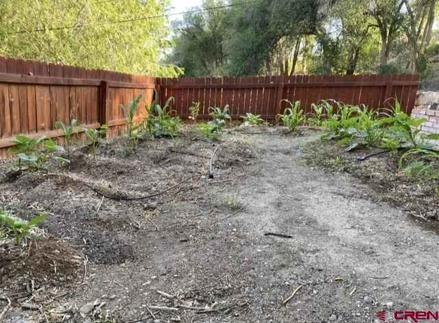 a view of outdoor space with deck and wooden fence