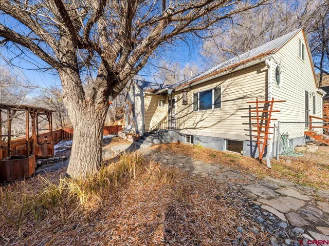 a view of a house with a snow in the yard