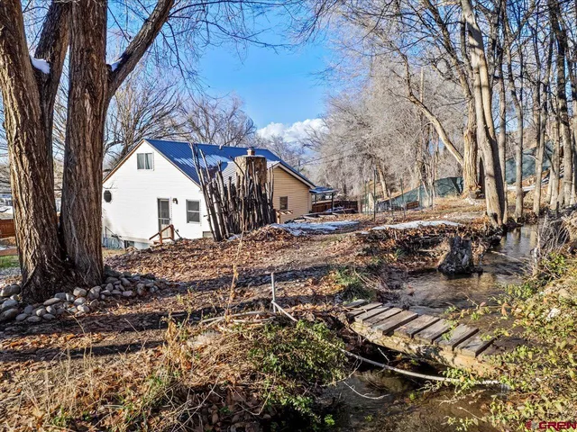 a view of house with a yard