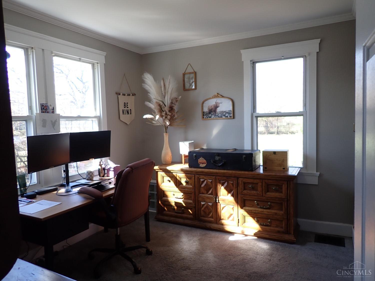 First floor bedroom being used as an office. Has adjoining full bathroom and built-in storage.