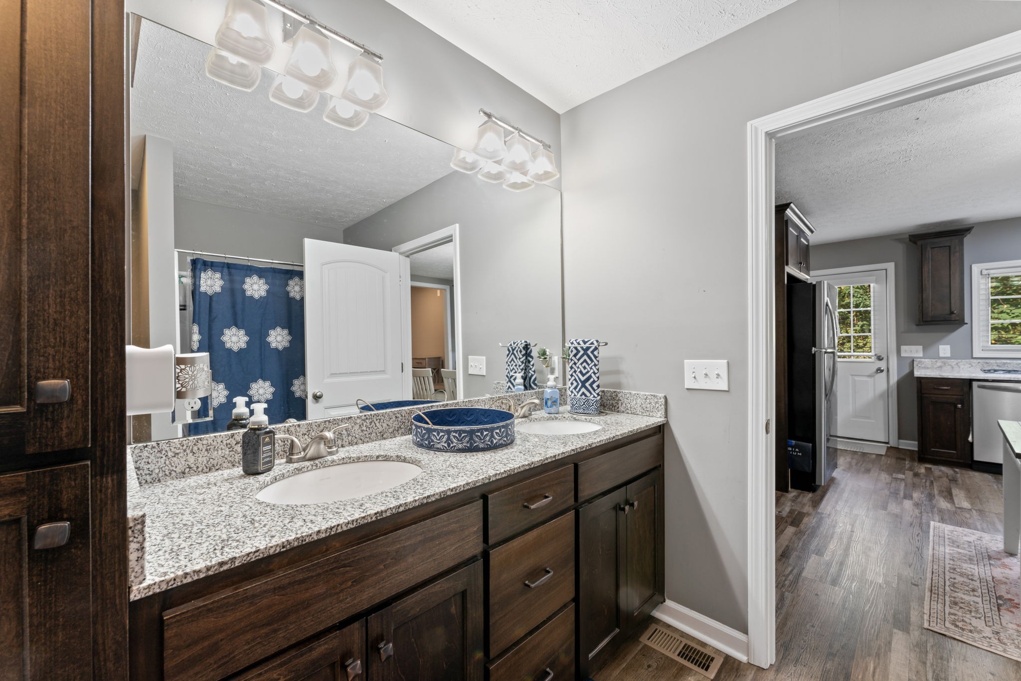 332 Oakwood Road Tullahoma, TN 37388 - Photo 14 of 17 a en suite bathroom with a granite countertop sink a mirror and a shower