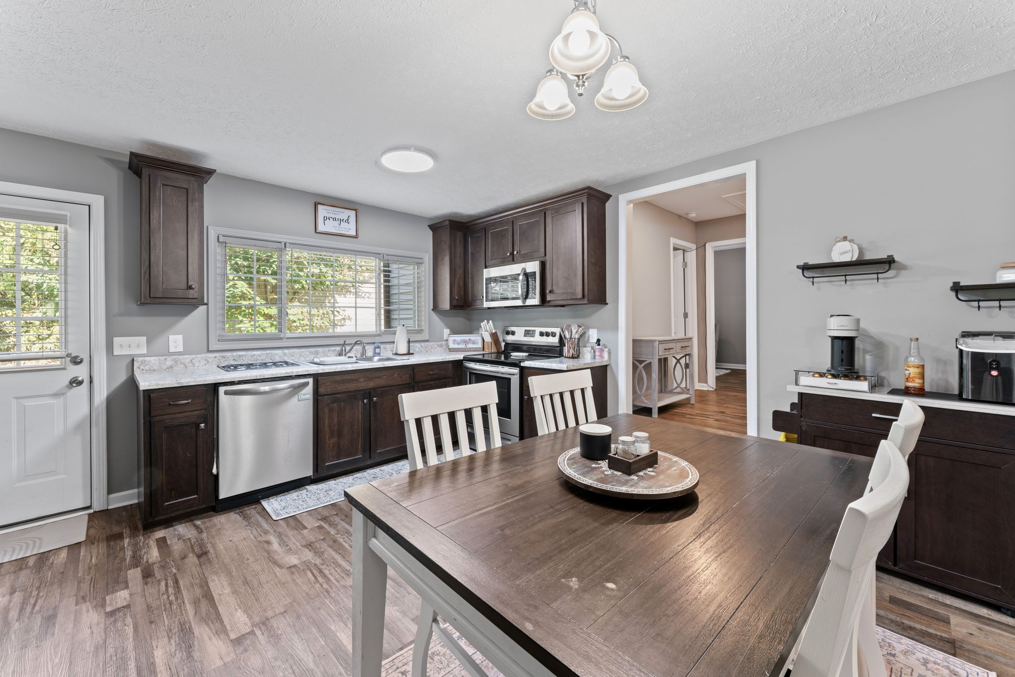 332 Oakwood Road Tullahoma, TN 37388 - Photo 7 of 17 a kitchen with stainless steel appliances kitchen island granite countertop a table chairs stove and cabinets