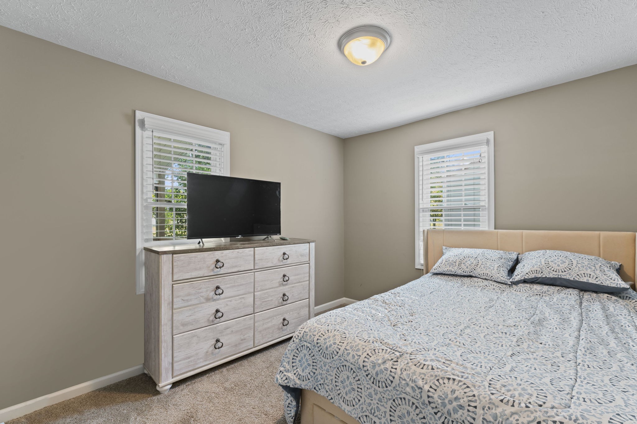 332 Oakwood Road Tullahoma, TN 37388 - Photo 9 of 17 a bedroom with a bed and a flat screen tv