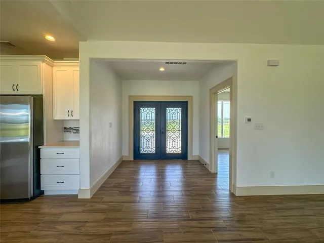 a view of hallway with wooden floor