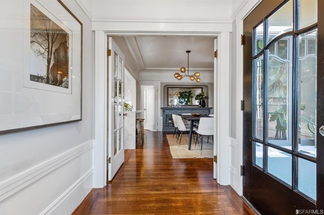 a large kitchen with stainless steel appliances a sink and a stove