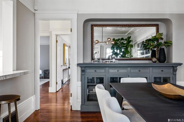 a spacious bedroom with two beds and painting on the wall