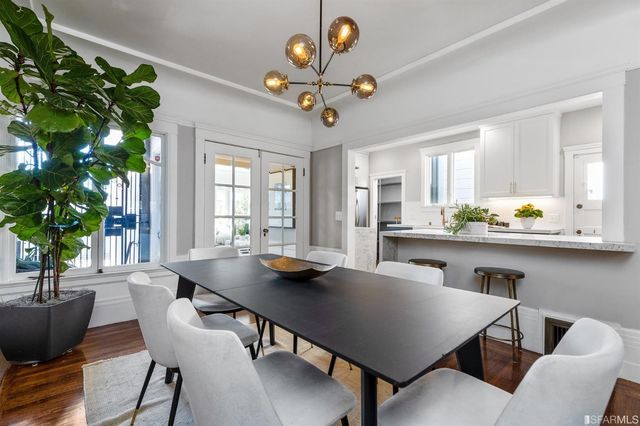 a bedroom with a bed lamp and a potted plant