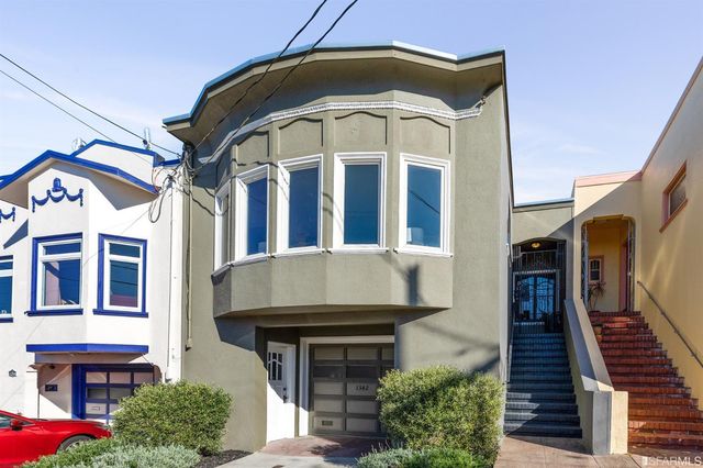 a living room with furniture a fireplace and a potted plant