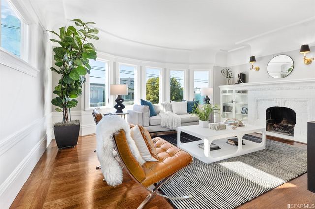 a living room with furniture a rug and a large window