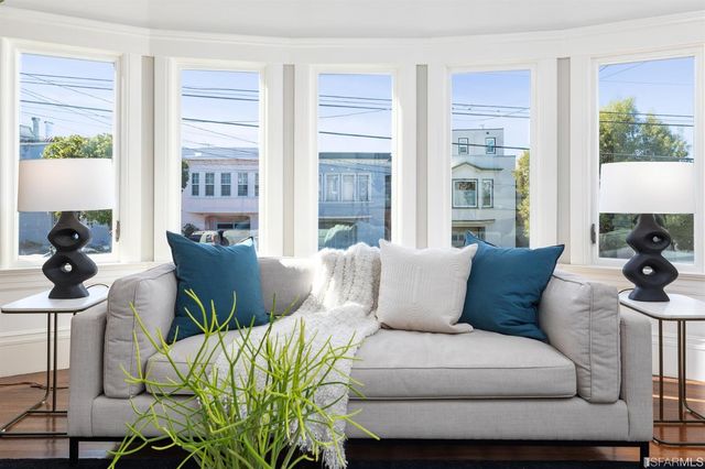 a dining room with chandelier and wooden floor