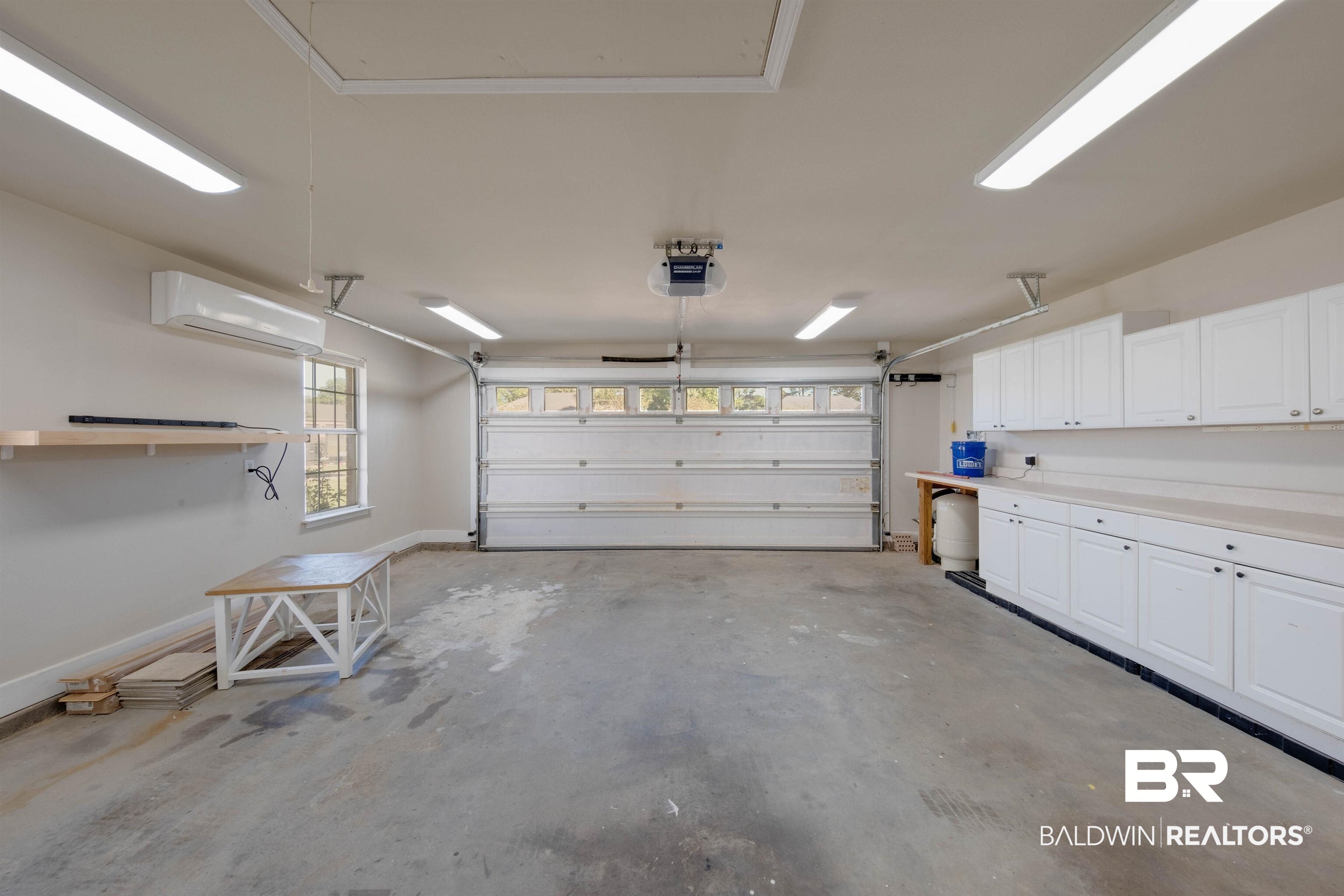9462 Lakeview Drive Foley, AL 36535 - Photo 22 of 50 Garage featuring a garage door opener and an AC wall unit