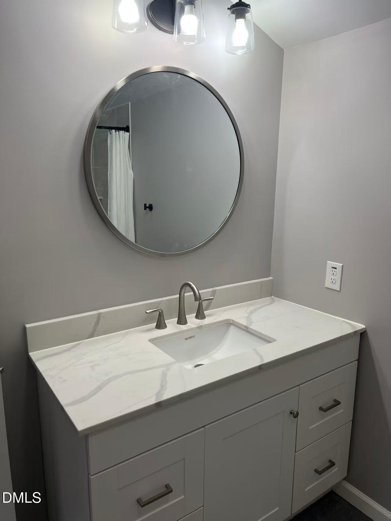 409 Rockingham Street Carthage, NC 28327 - Photo 28 of 56 a bathroom with a sink and a mirror