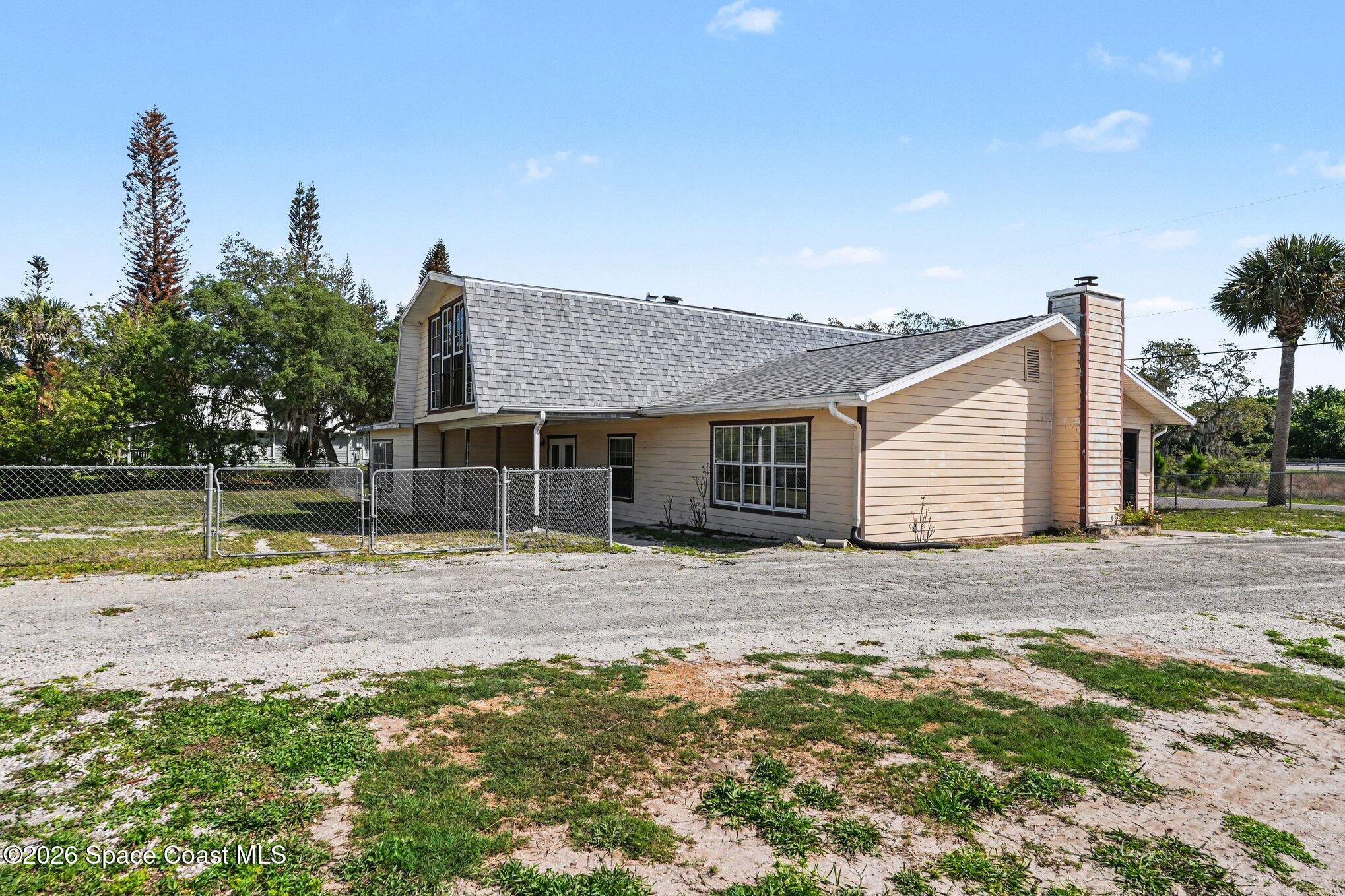 4950 Blounts Ridge Road Mims, FL 32754 - Photo 30 of 40 a front view of a house with garden