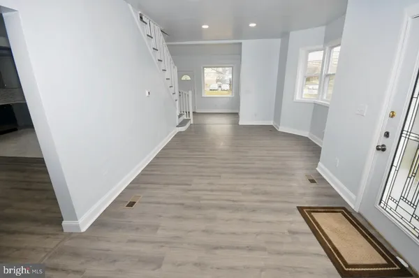 a view of an entryway with wooden floor