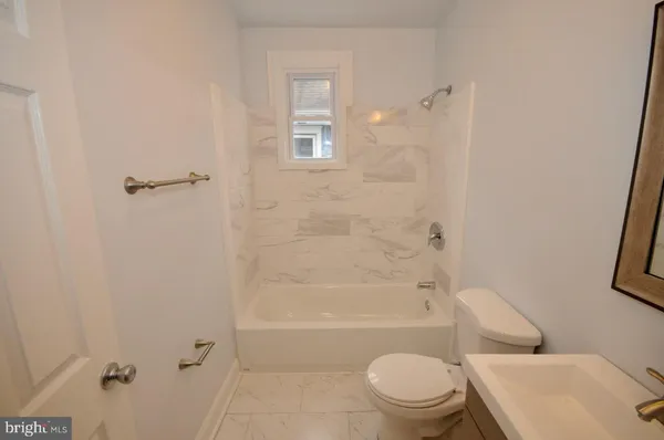 a bathroom with a toilet and shower