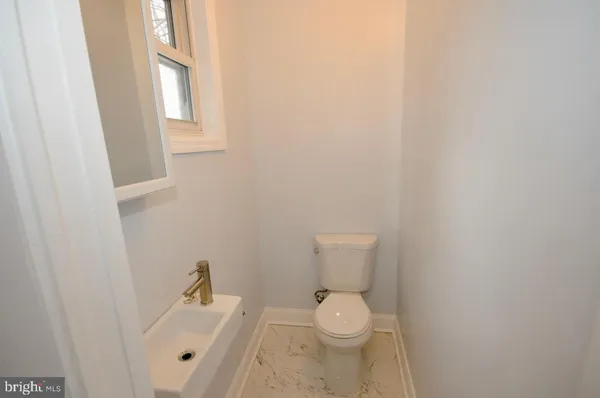 a white toilet sitting next to a sink