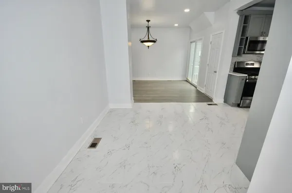 en empty room with wooden floor and windows