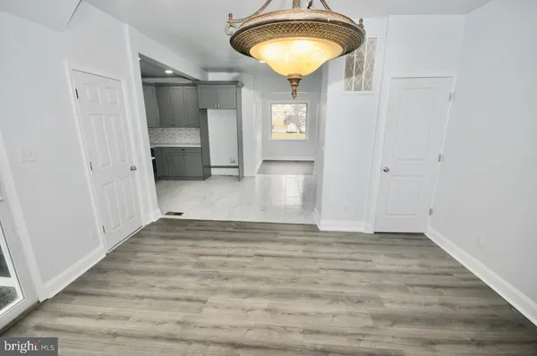 a view of an empty room with a chandelier