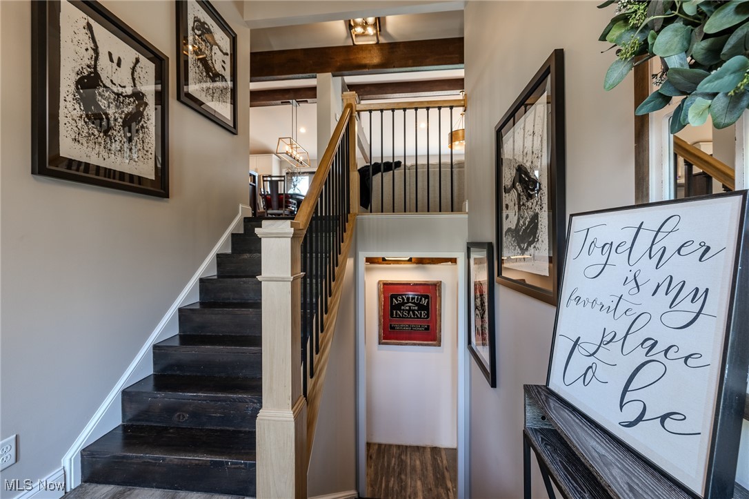 6268 Summers Road Windsor, OH 44099 - Photo 12 of 49 Stairs with wood finished floors and a chandelier