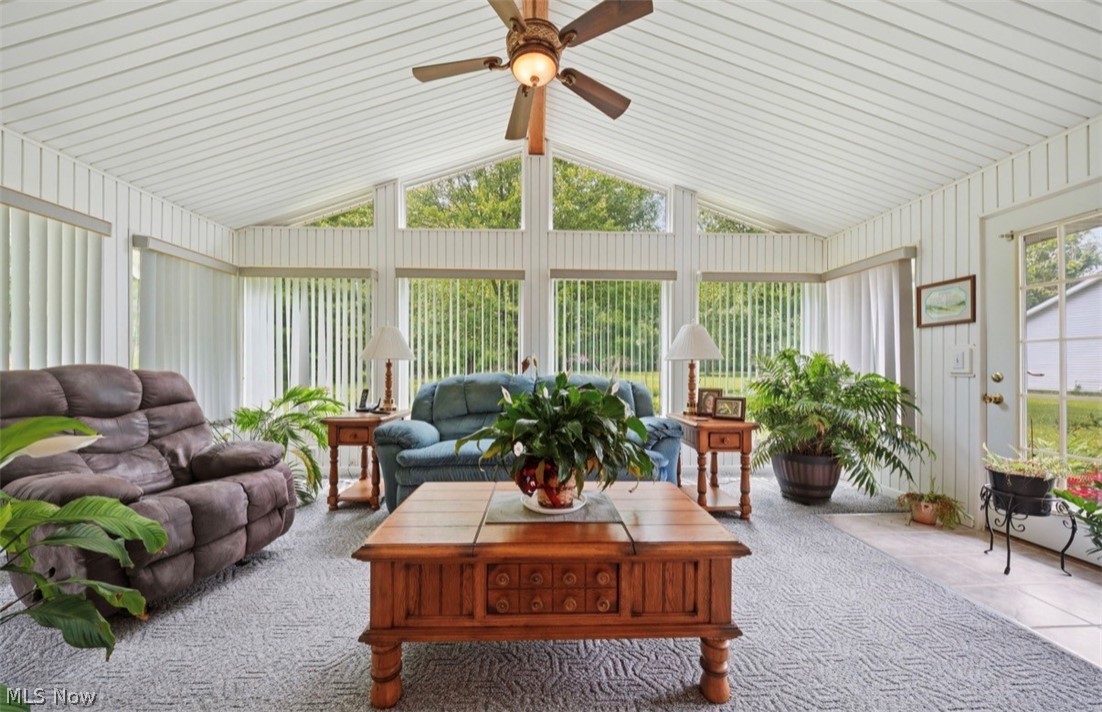 3556 Lake Road Conneaut, OH 44030 - Photo 20 of 39 Sunroom featuring a vaulted ceiling with white paneling and a ceiling fan