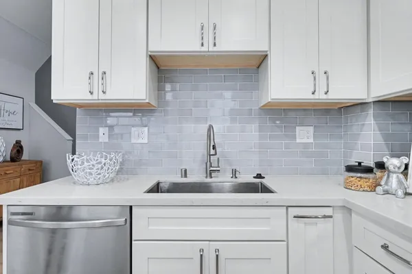 a kitchen with stainless steel appliances a sink and cabinets