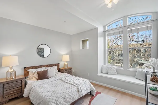 a bedroom with bed and a large window
