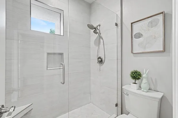 a bathroom with a shower a sink and mirror