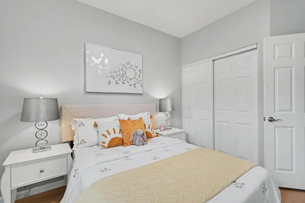 a bedroom with a bed and a night stand