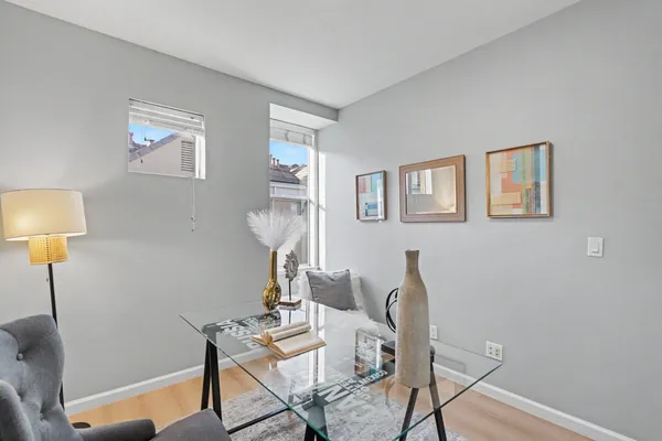 a view of a workspace with furniture and a window