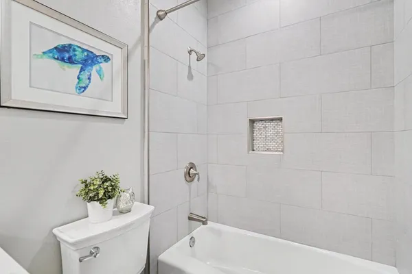 a bathroom with a sink a toilet and bathtub