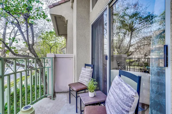 a view of a balcony with chair and potted plants