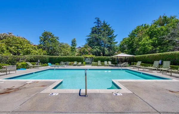 a view of a swimming pool and a yard